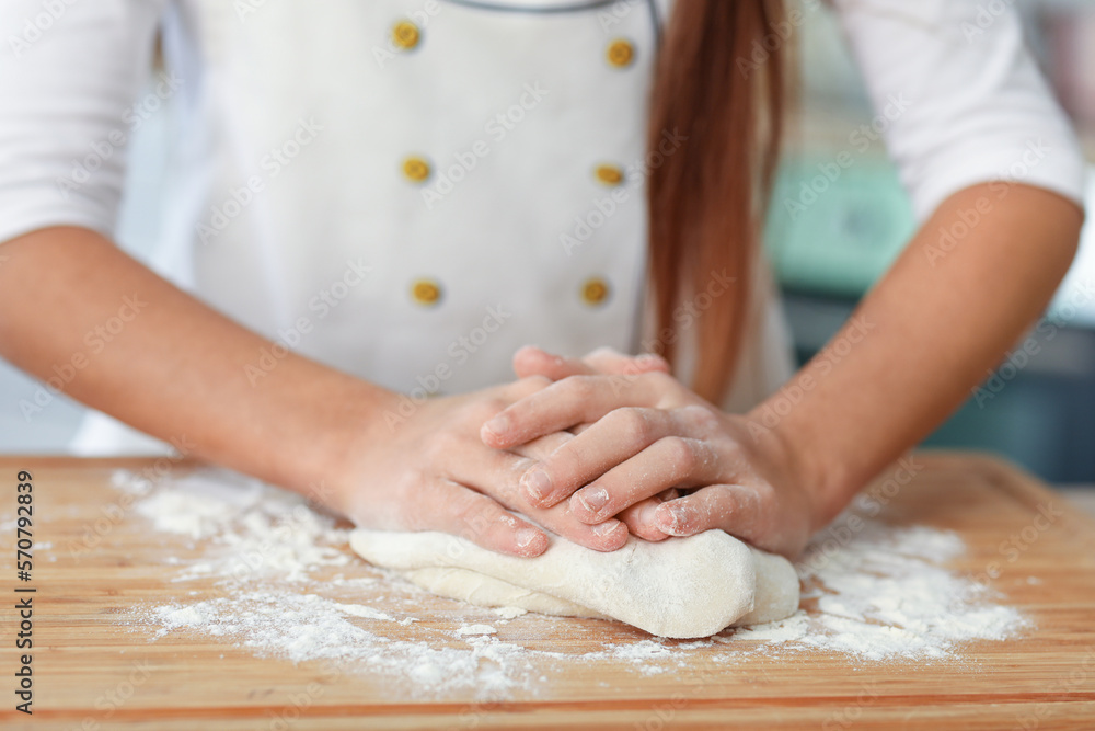 Little baker making dough in kitchen, closeup