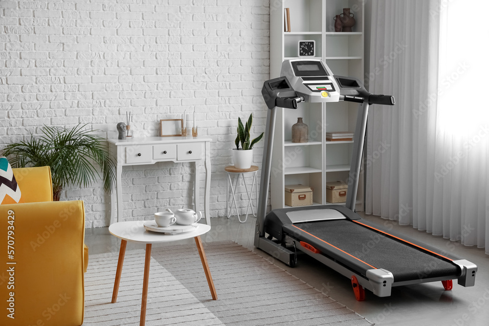 Interior of living room with modern treadmill