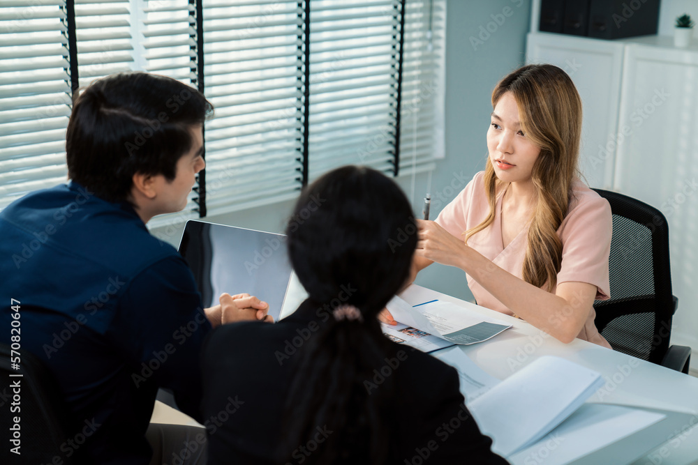 A young female asian candidate tries to impress her interviewer by being competent. International co