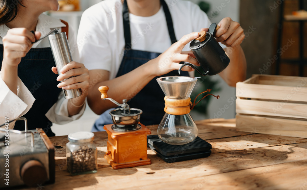 Cute couple, male and female barista working in coffee shop Barista working at cafe Alternative ways