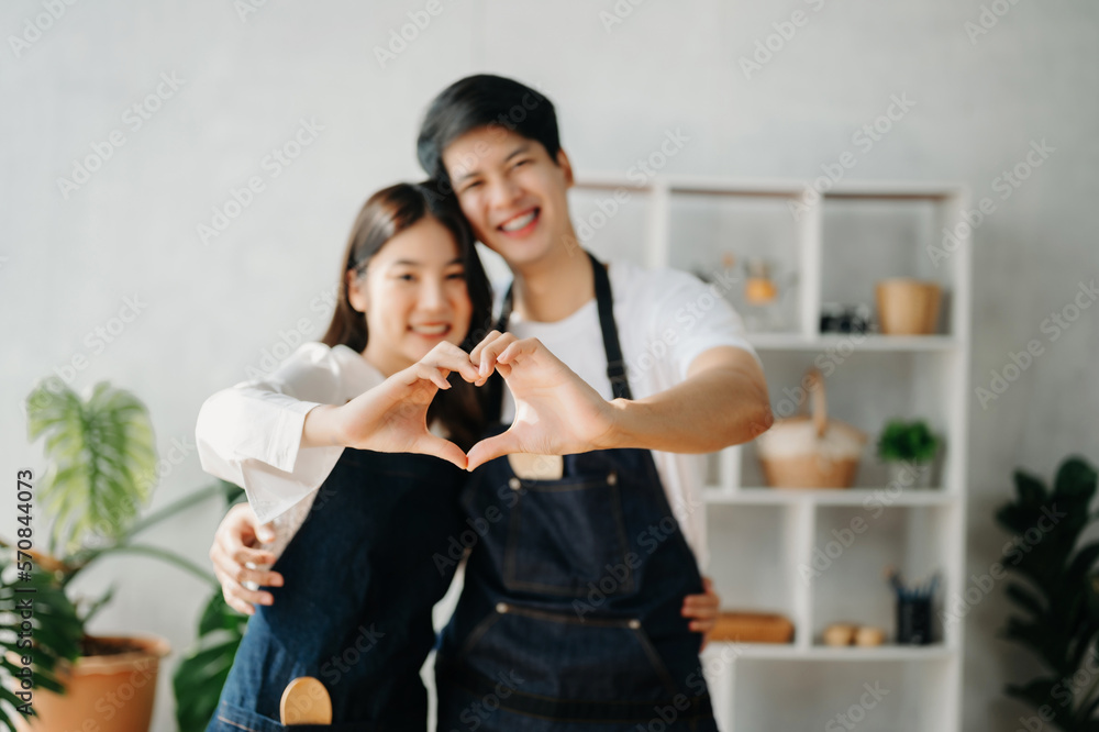 Happy asia young couple cooking together with vegetables with Bread and fruit in cozy on wooden kitc