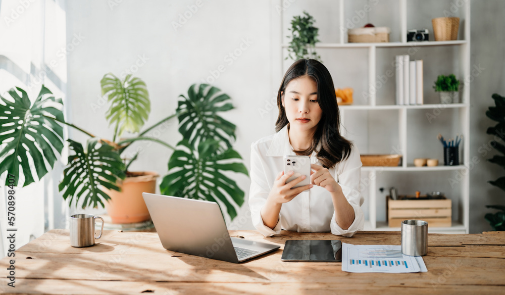  Working woman concept a female manager attending video conference and holding tablet, smatrphone an