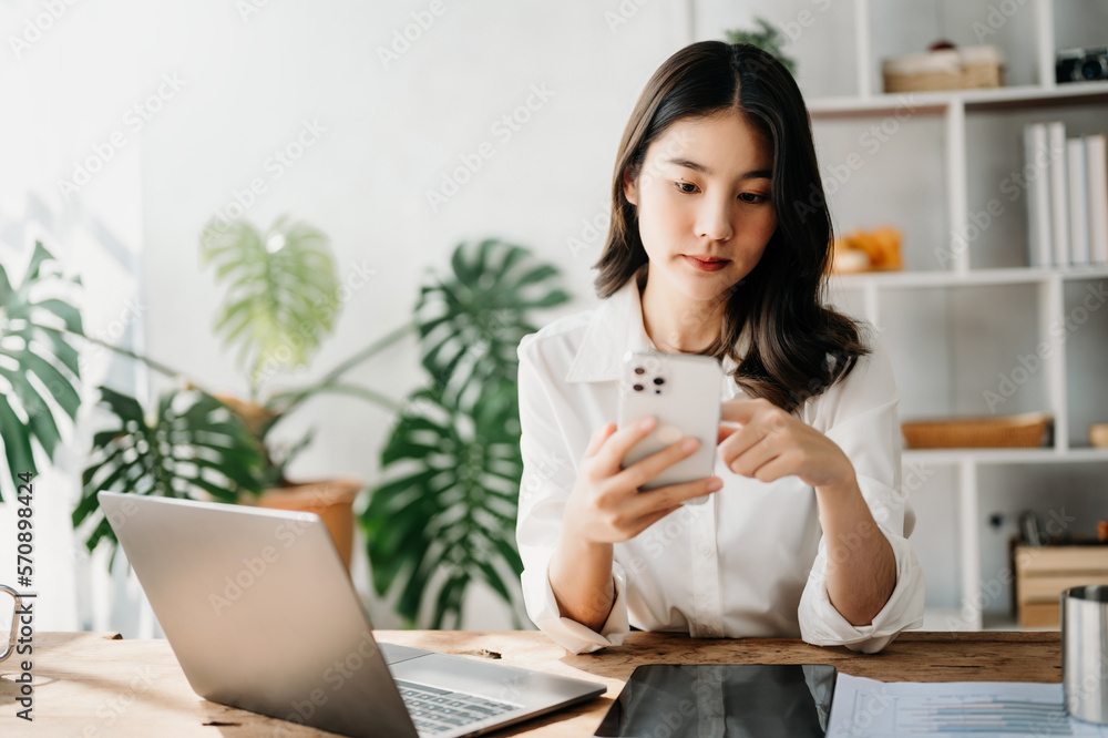  Working woman concept a female manager attending video conference and holding tablet, smatrphone an