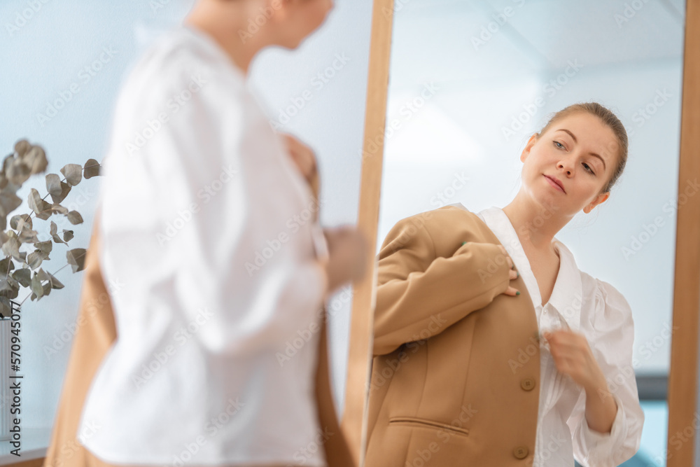 woman looking at her reflection in mirror