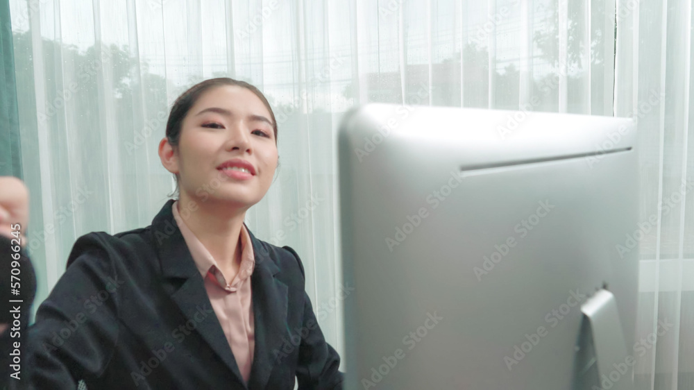 Young enthusiastic female operator put on headphone, looked into camera, and start working instantly