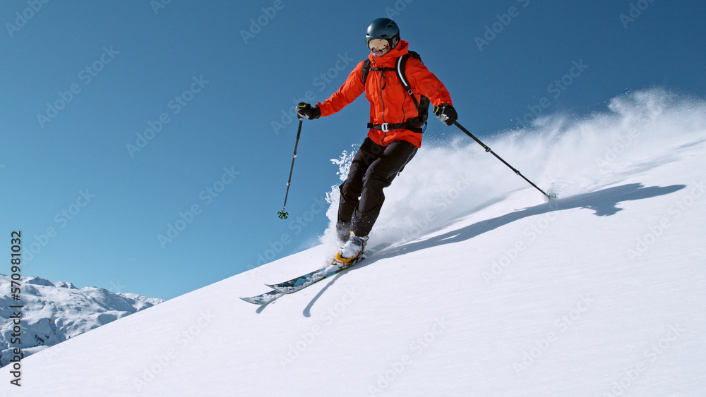 Free ride skier running down the hill.