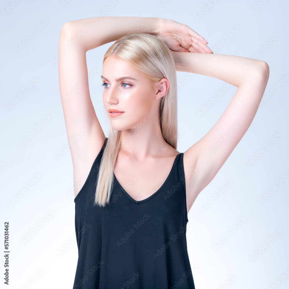 Personable woman lifting her armpit showing hairless hygiene underarm as beauty posing for cleanline