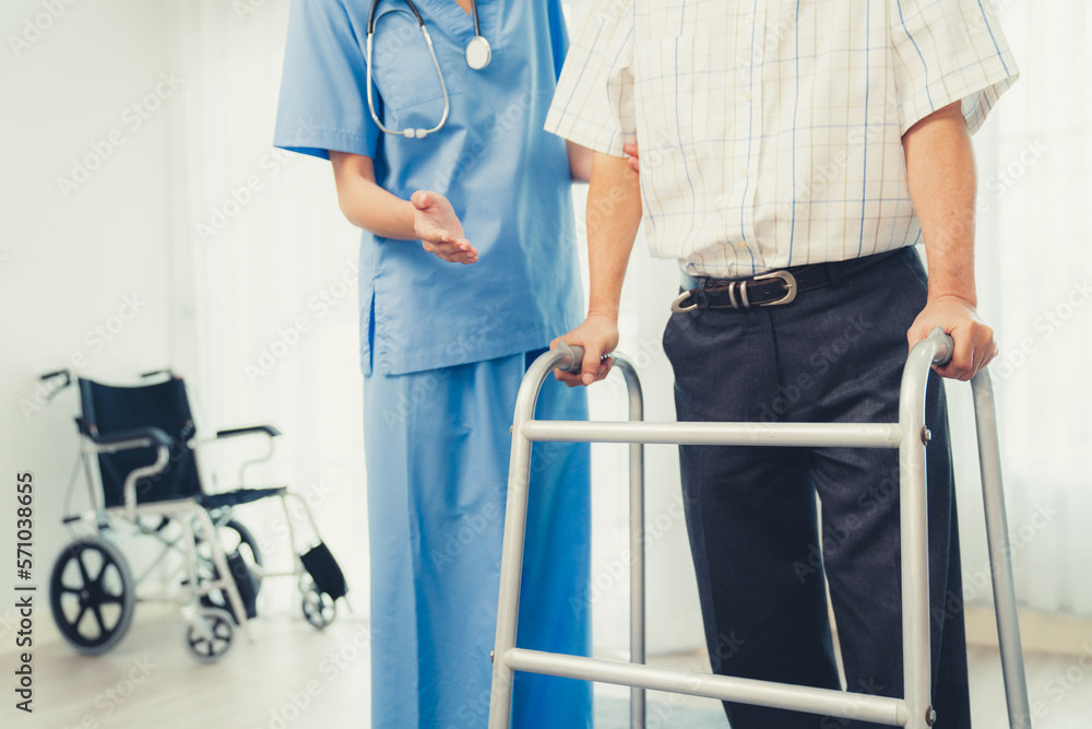 Physiotherapist assists contented senior man on folding walker. Recuperation for elderly, seniors ca