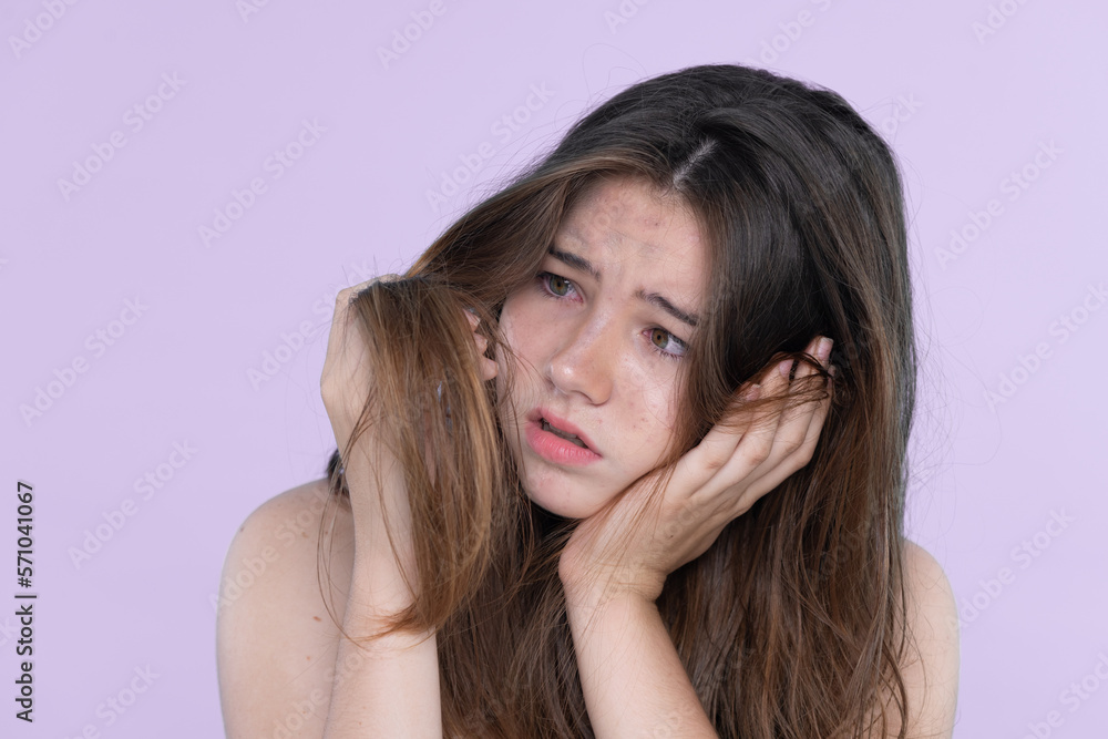 Beautiful girl feel sad, worry about her damaged hair with isolated background. Concept of dry lifel