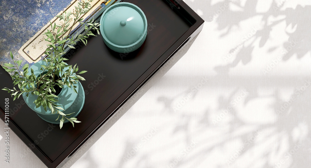 Dark wooden serving tray, ceramic turquoise blue vase and jar and antique blue Chinese book with spa