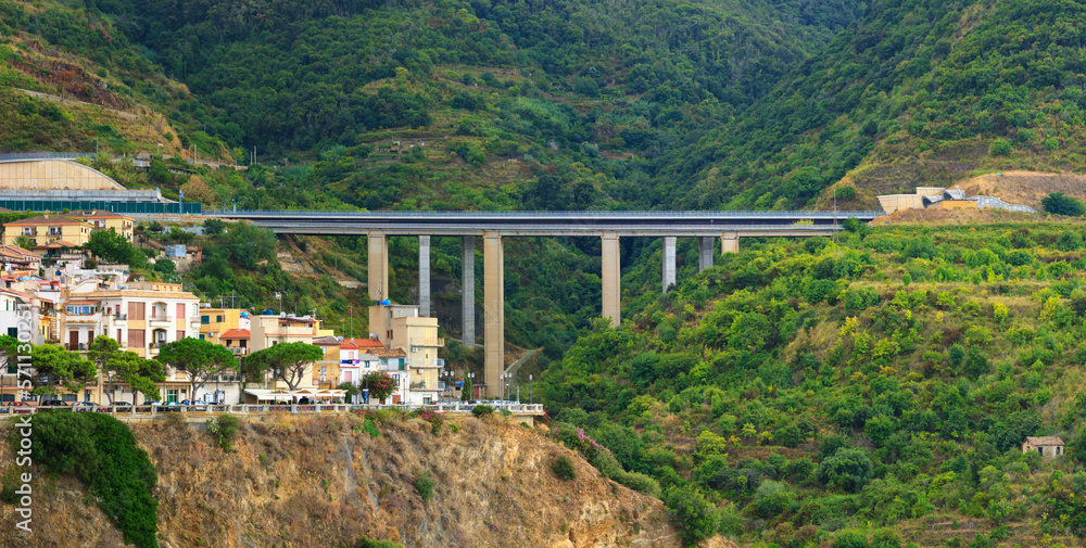 Landscape with Italian Scilla town and bridge highway on green mountain hills