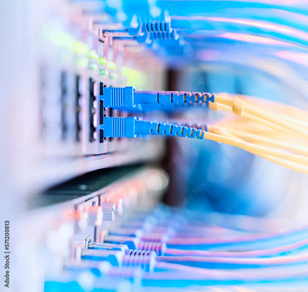 Fiber Optical cables connected to an optic ports and Network cables connected to ethernet ports