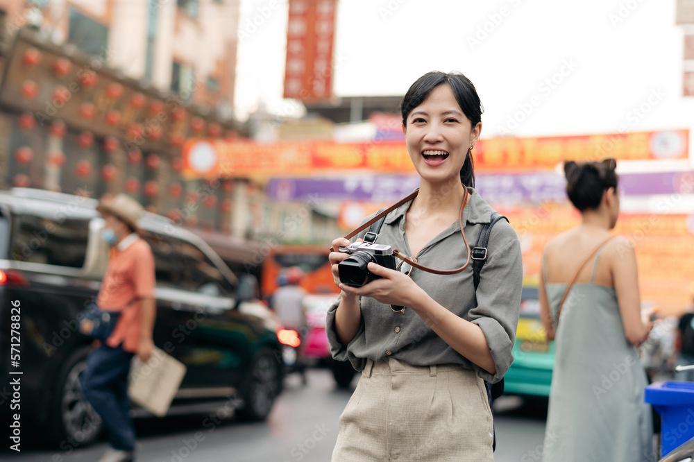 Young Asian woman backpack traveler enjoying China town street food market in Bangkok, Thailand. Tra