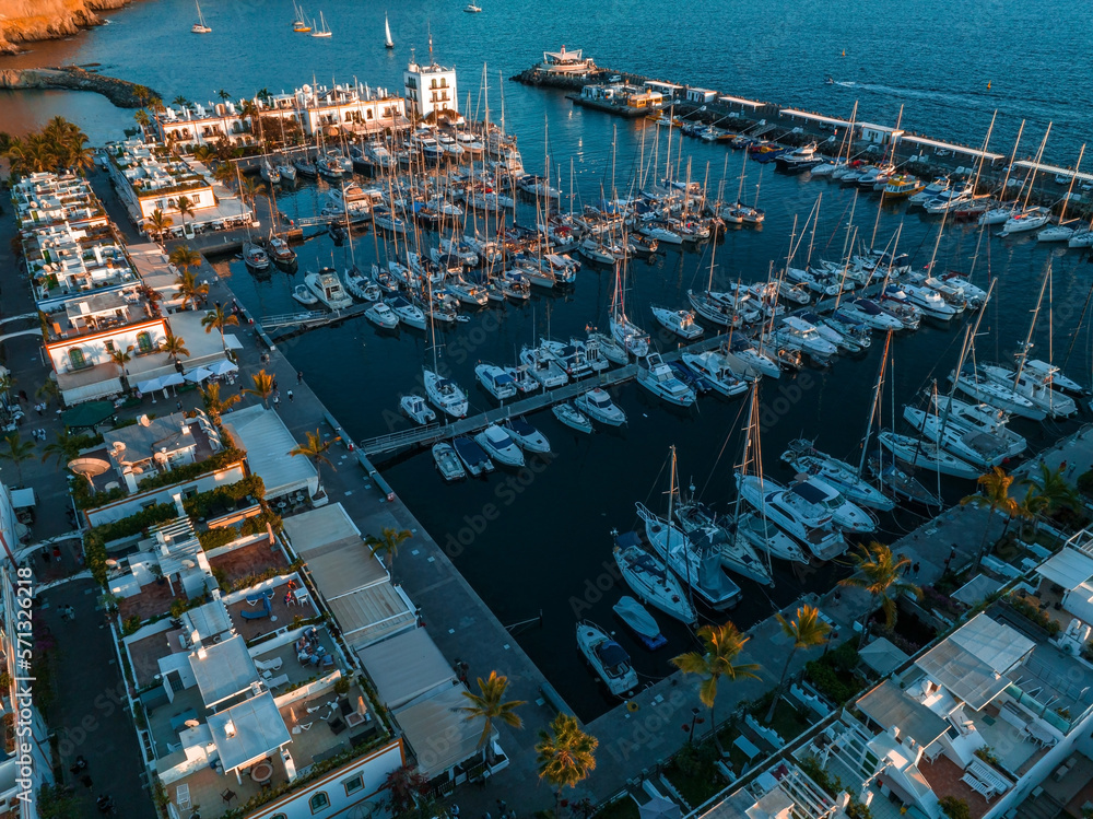 Luxury yachts docked by the golden coast of Spain during magical sunset lights. Luxury holiday conce