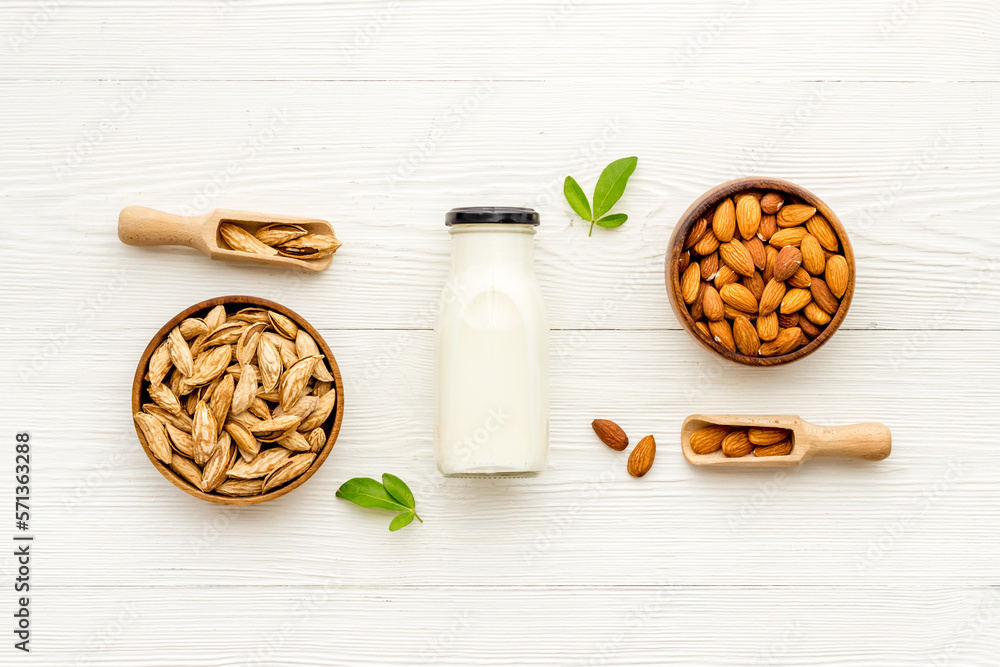 Sweet almond milk in bottle with almond seeds