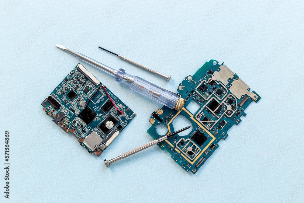 Electronics checkup - circuit board with microchips and tools, top view