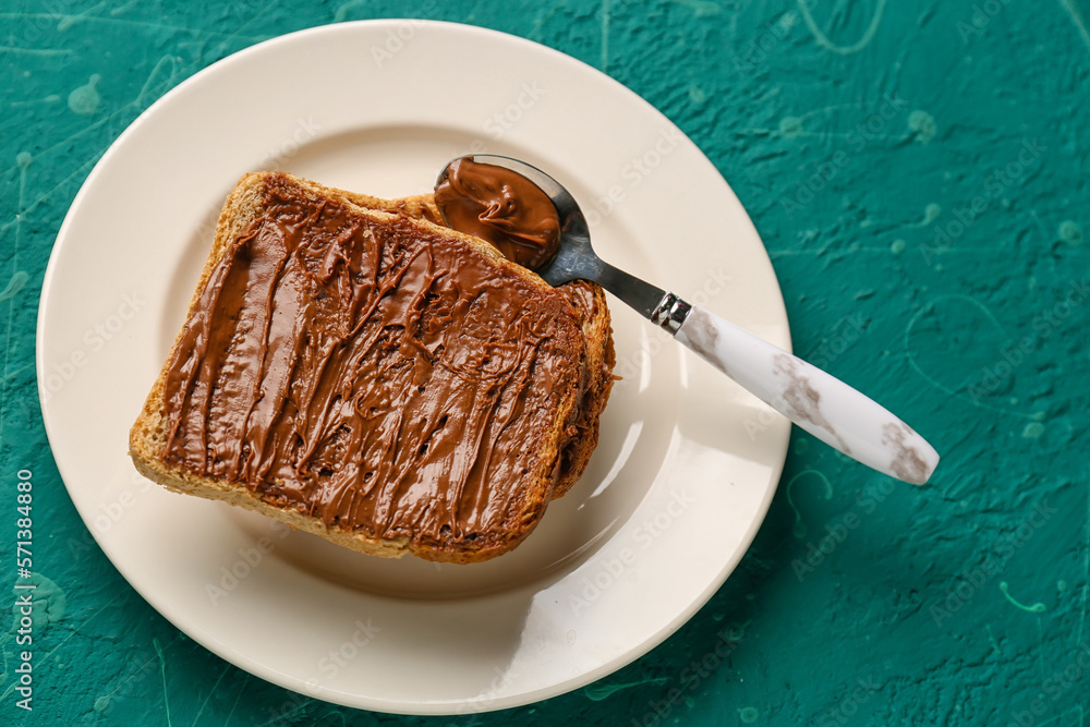 Plate of tasty toasts with hazelnut butter on color background