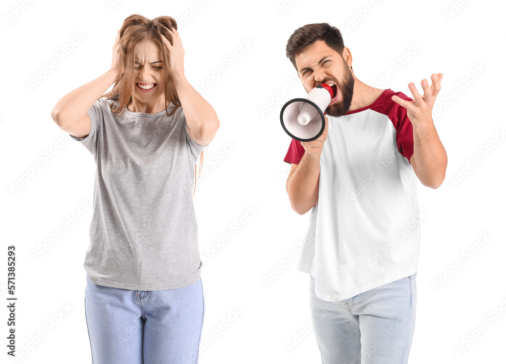 Young man with megaphone shouting at his wife on white background