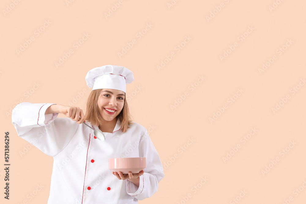 Female chef with spoon and bowl on beige background