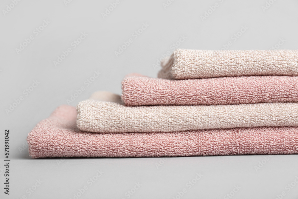 Stack of folded cotton towels on white background, closeup