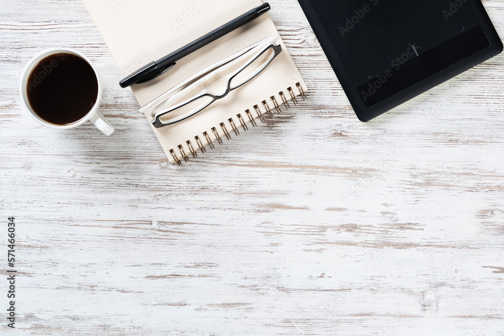 Top view office desk with white cup of coffee