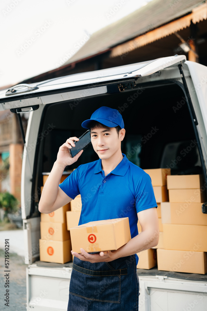 Happy delivery man standing with arms crossed near van outside the warehouse. This is a freight tran