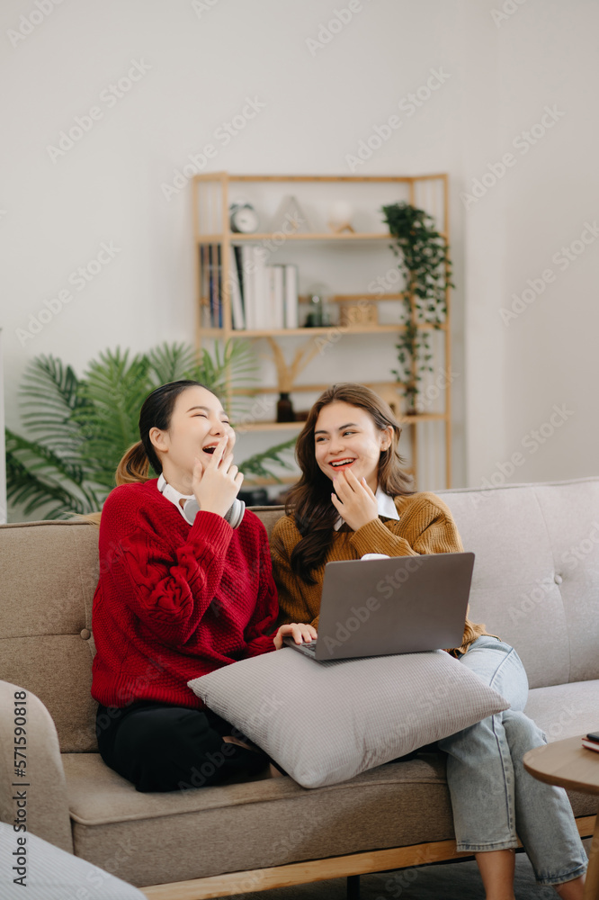 Two asian beauty smiling young women sitting on sofa Attractive casual girl feel happy and relax,hav