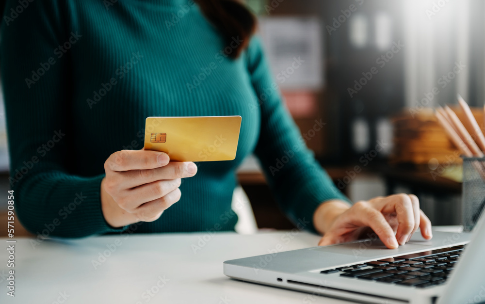 Woman using smart phone for mobile payments online shopping,omni channel,sitting on table,virtual ic