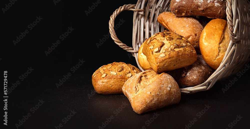 Basket with appetizing rolls on a black background