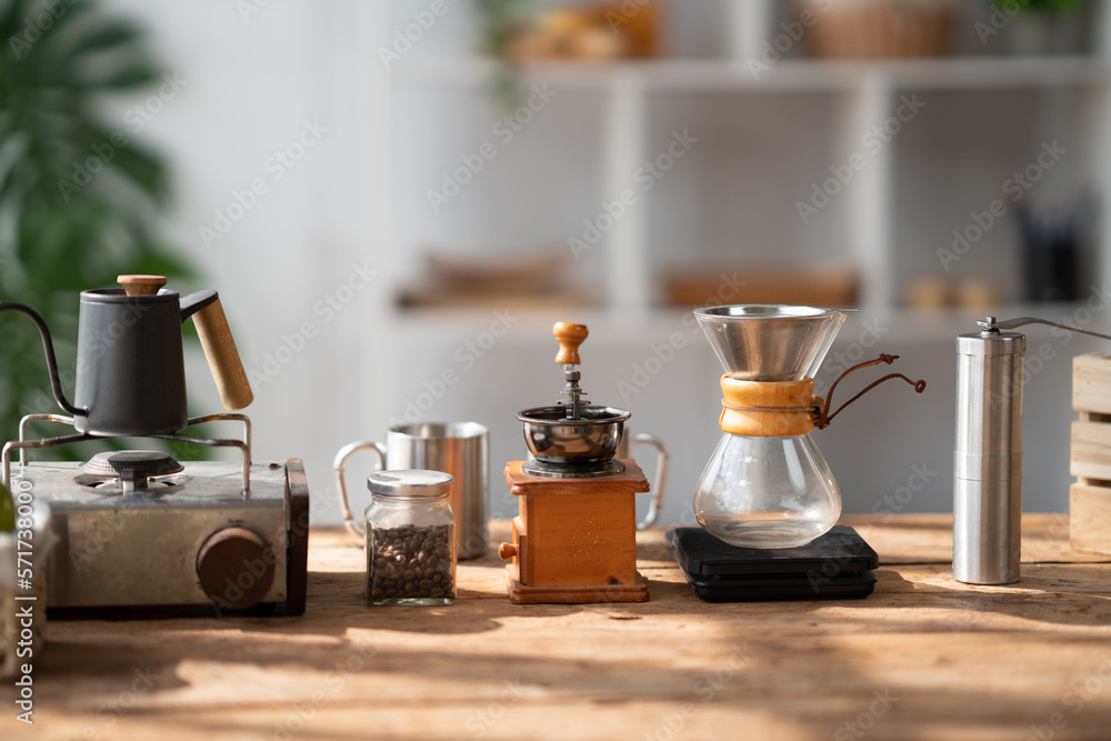 Coffee making concept, Old coffee grinder, manual hand mill on the table with coffee pot and coffee 