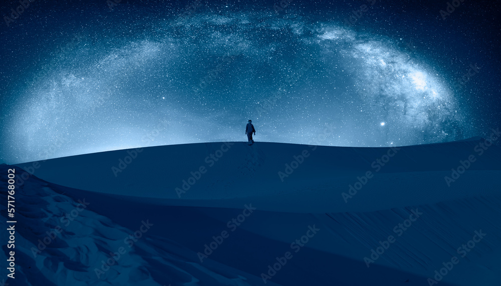 Happy bedouin in traditional dark blue clothing standing on sand in Sahara desert with Milky Way gal