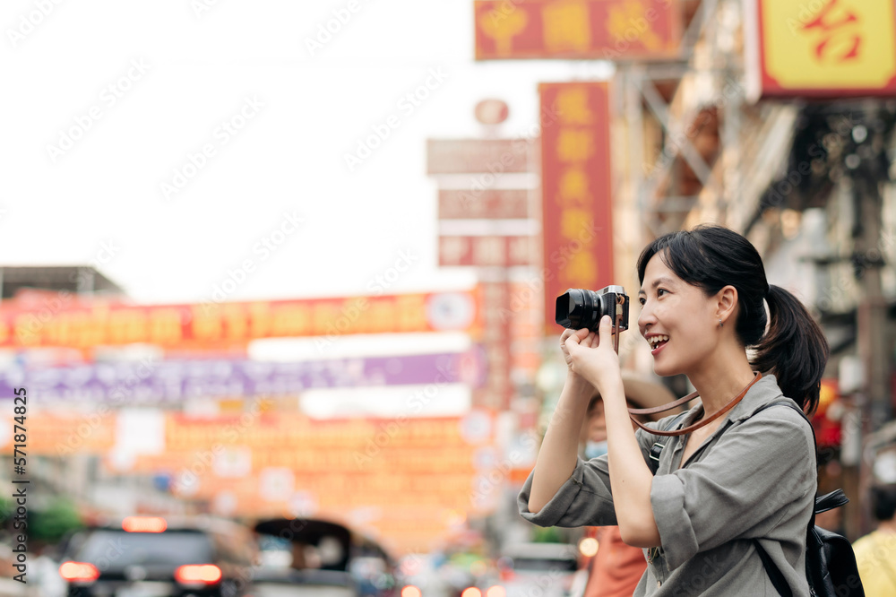 Young Asian woman backpack traveler enjoying China town street food market in Bangkok, Thailand. Tra