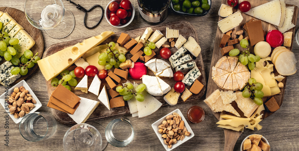 Variety of cheese kinds served with grape, honey and olives for gourmet nutrition. Organic parmesan,