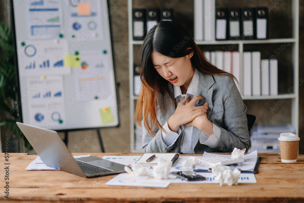 Asian business woman is stressed, bored, and overthinking from working on a tablet at the modern off