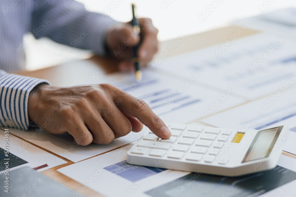 Businessman working with financial documents analyzing business finances and planning budget managem