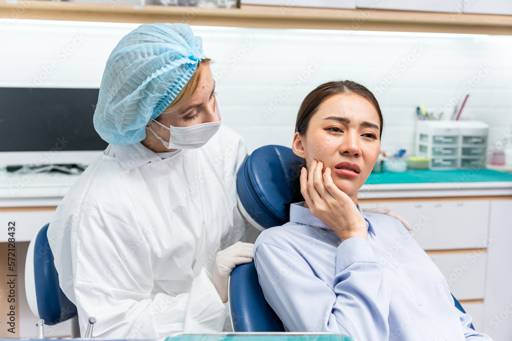 Caucasian dentist examine tooth for young girl at dental health clinic