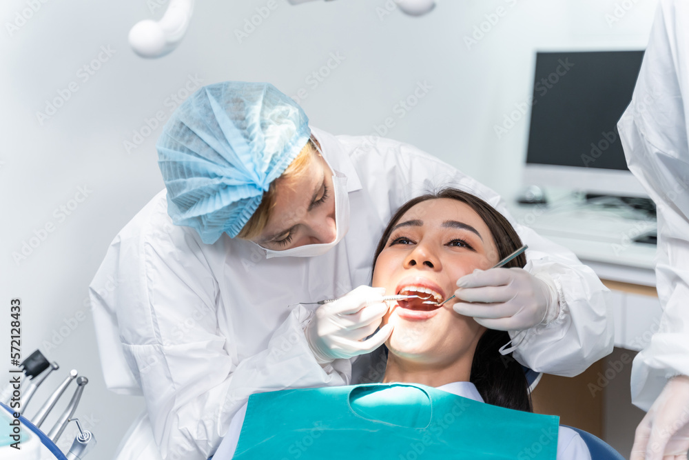 Caucasian dentist examine tooth for young girl at dental health clinic