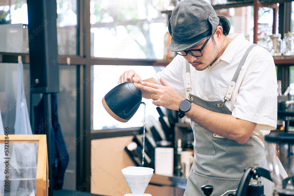 Asian attractive male barista or waiter working in coffeehouse shop. 