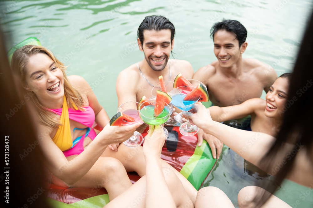 Group of diverse friend drinking alcohol, having a pool party together