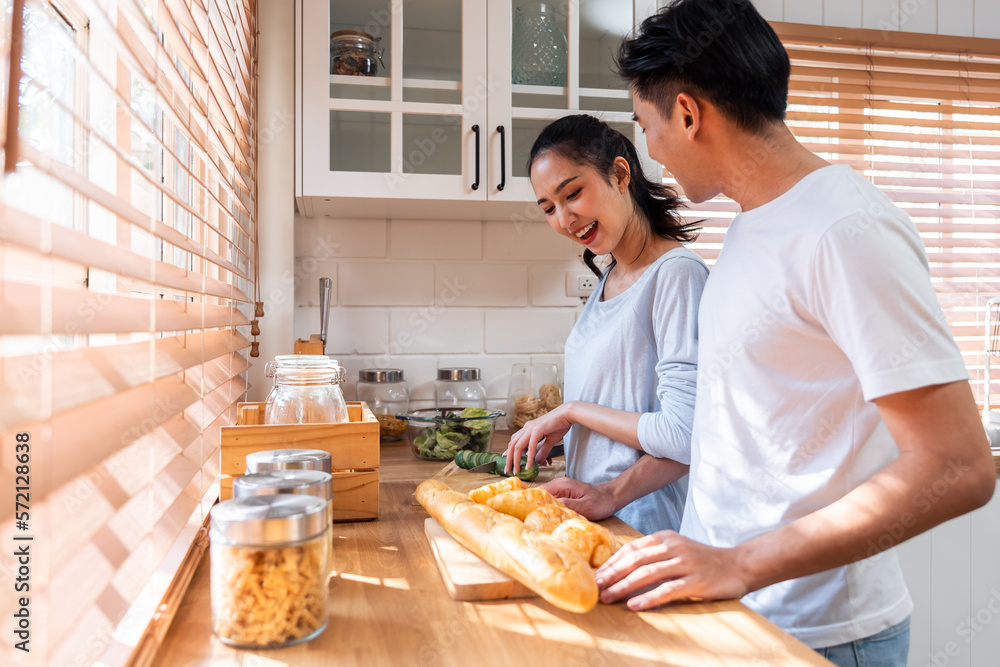 Asian new marriage couple baking bread and croissant together in house