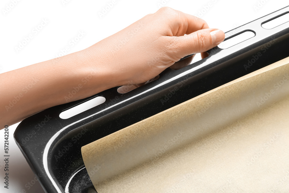 Female hand with baking sheet on white background, closeup