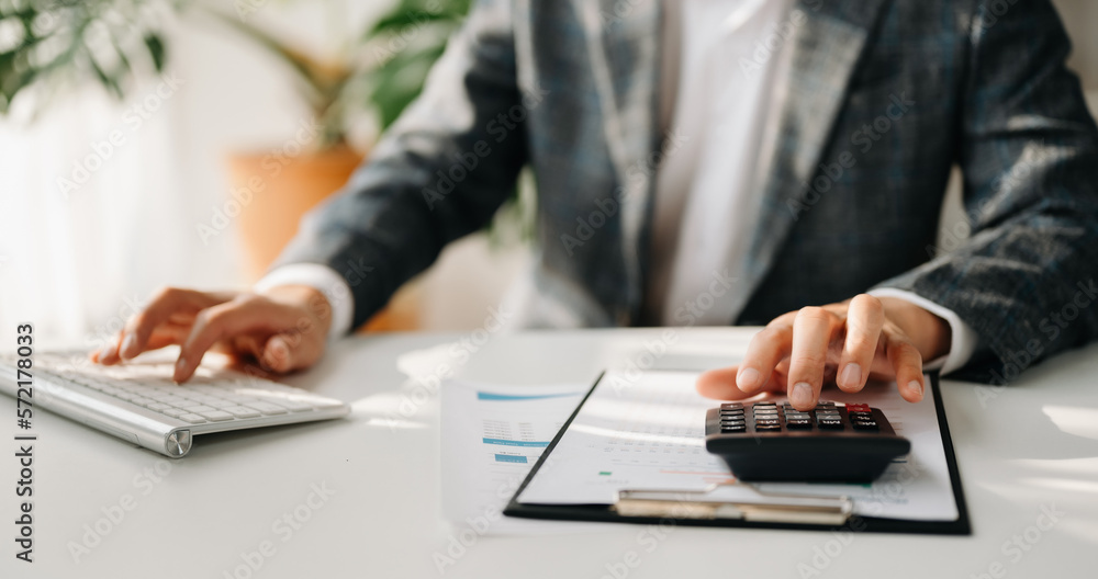 Close up of businessman or accountant hand typing laptop working to calculate on desk about cost at 