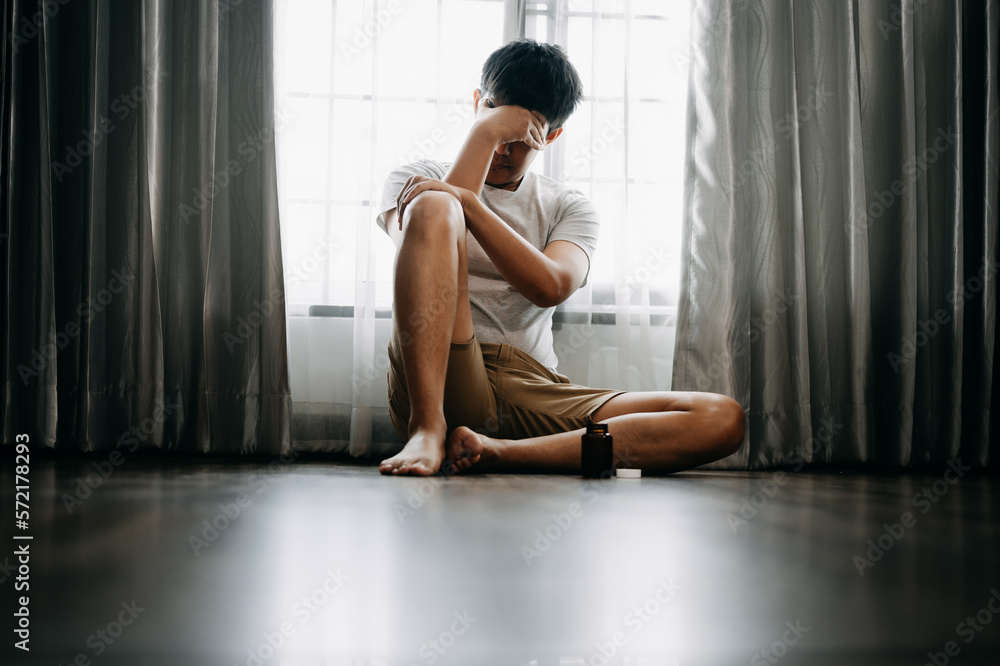 Asian Man sit Depression Dark haired  pensive glance Standing by window and anxiety Copy space.