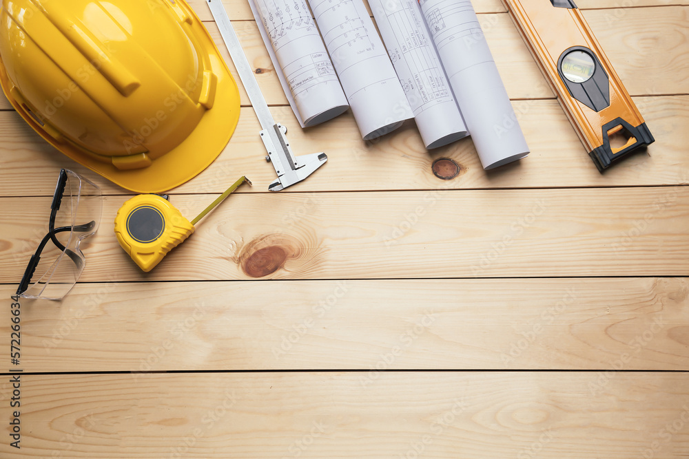 Work safety. Standard Construction site protective equipment on  top view wooden background, flat la