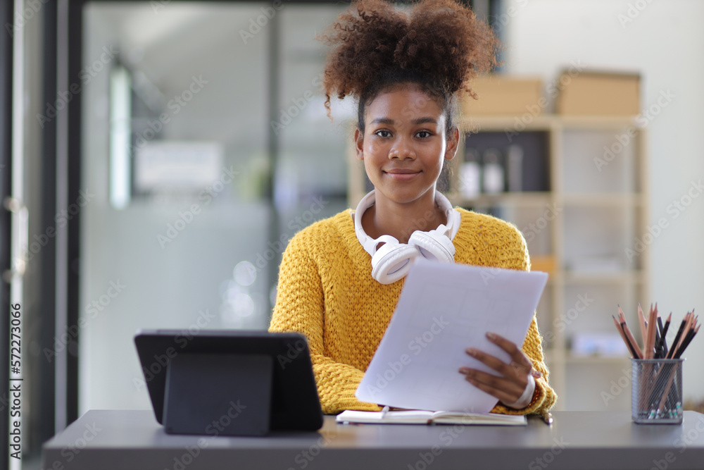 Portrait of a happy african woman in her home office.