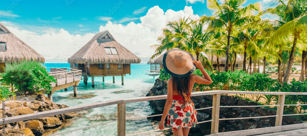 Tahiti hotel woman tourist at resort by beach. Vacation travel in Bora Bora, French Polynesia landsc