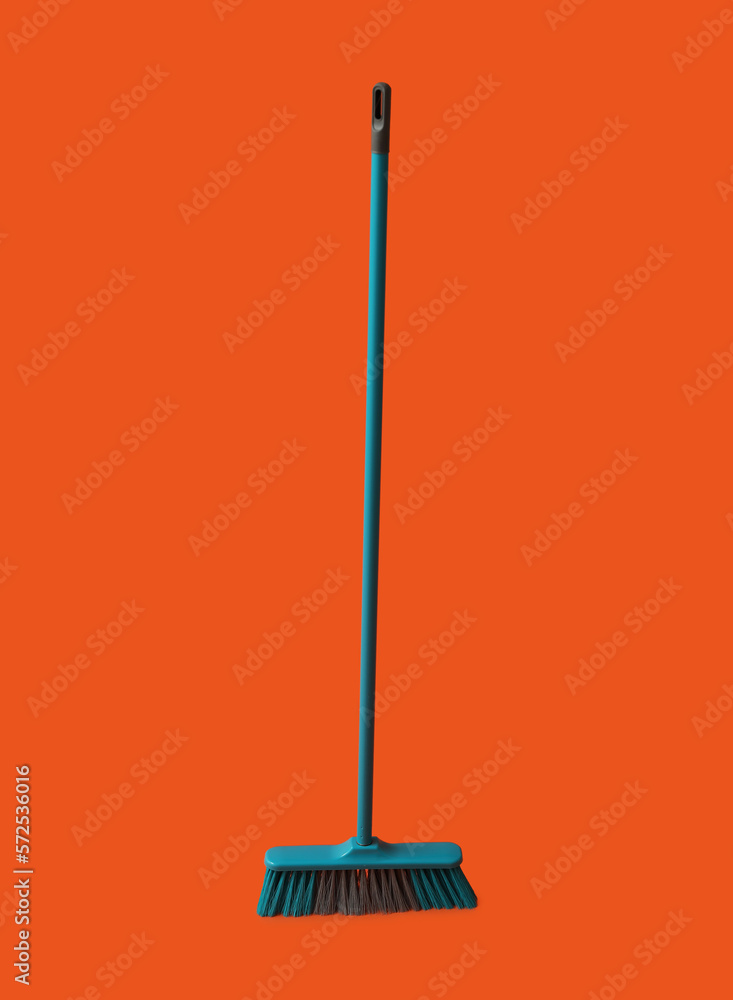 Plastic broom for cleaning on color background