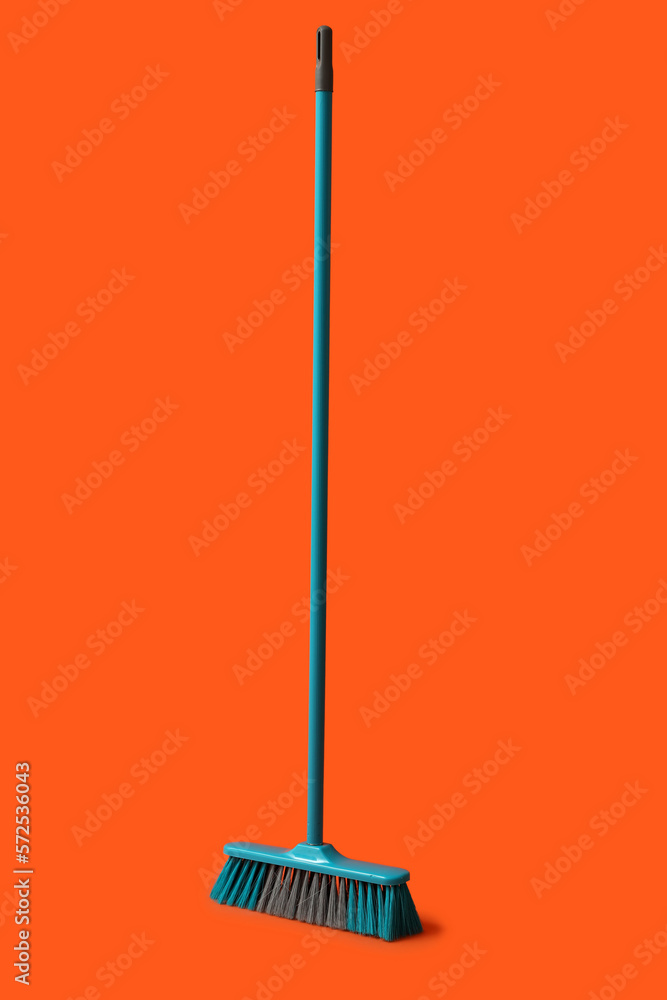 Plastic broom for cleaning on color background