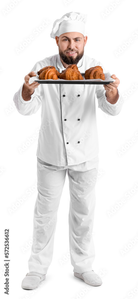 Male baker with tray of tasty croissants on white background