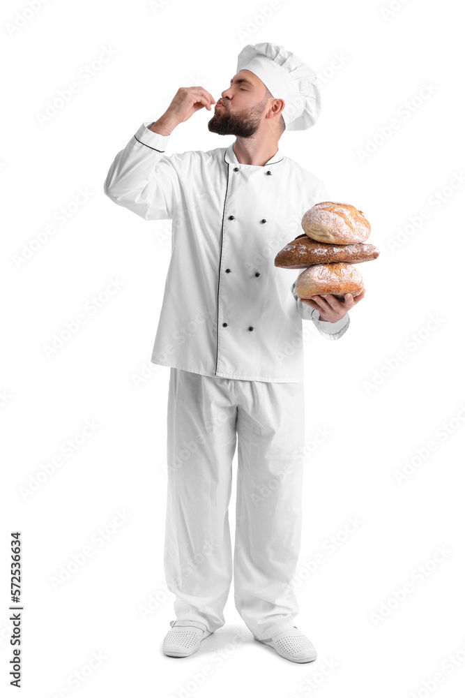 Male baker with loaves of fresh bread on white background